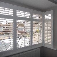 Clean horizontal lines make for a contemporary style in square bay windows