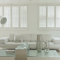 Soft white shutters create an effortlessly cool style